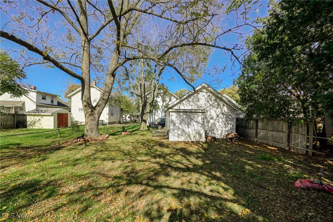Fenced backyard with a storage shed