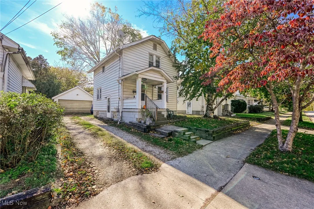 View of front structure and a detached garage