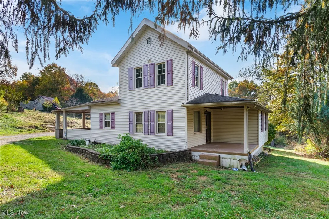 View of side of property featuring a yard