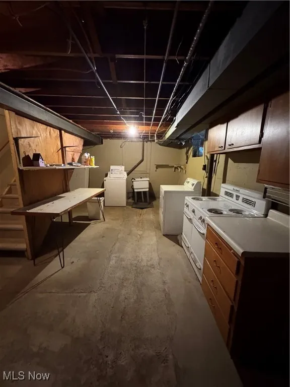 Unfinished below grade area featuring washer and clothes dryer and a sink