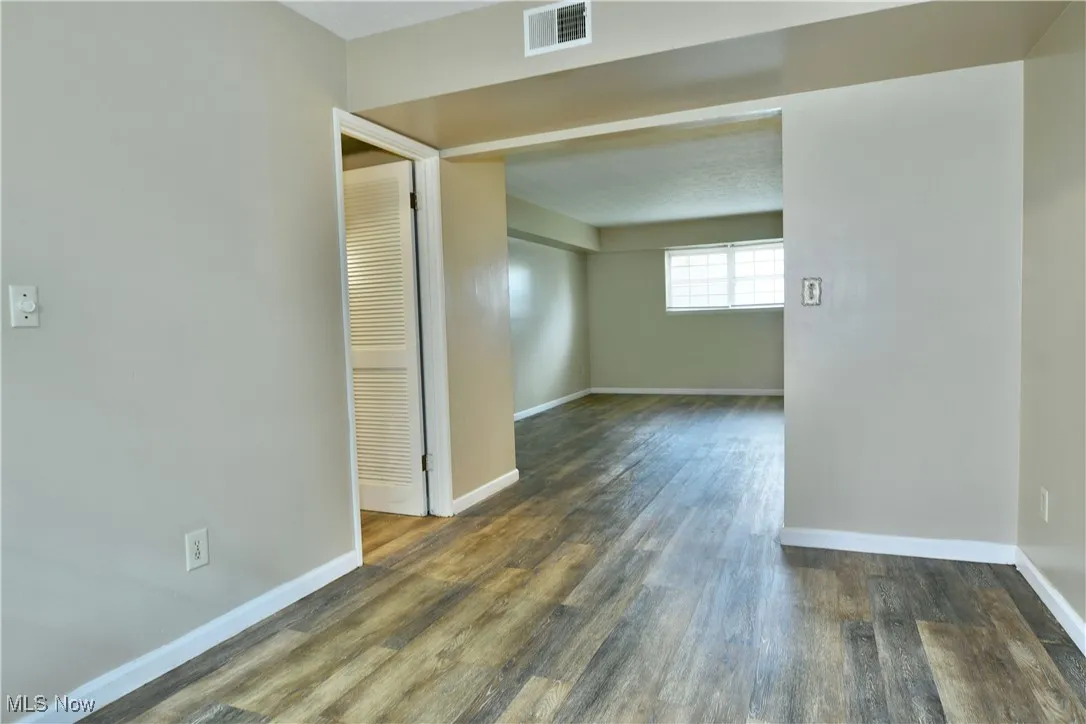 Unfurnished room with dark wood finished floors