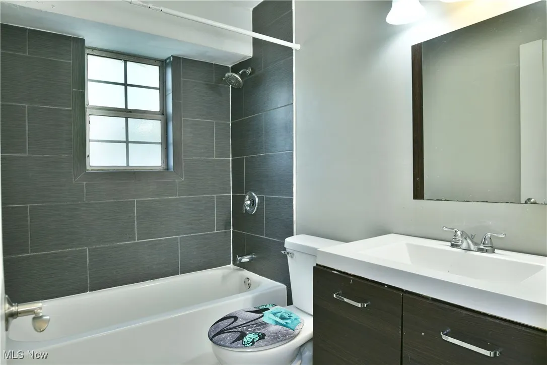 Bathroom with vanity and shower / bath combination