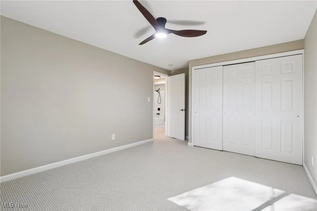 Unfurnished bedroom with carpet floors, a closet, and ceiling fan