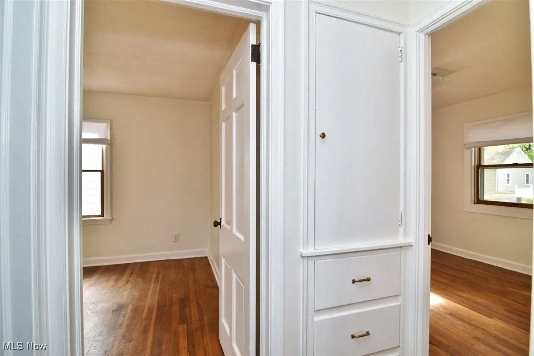 Hallway with dark wood-type flooring