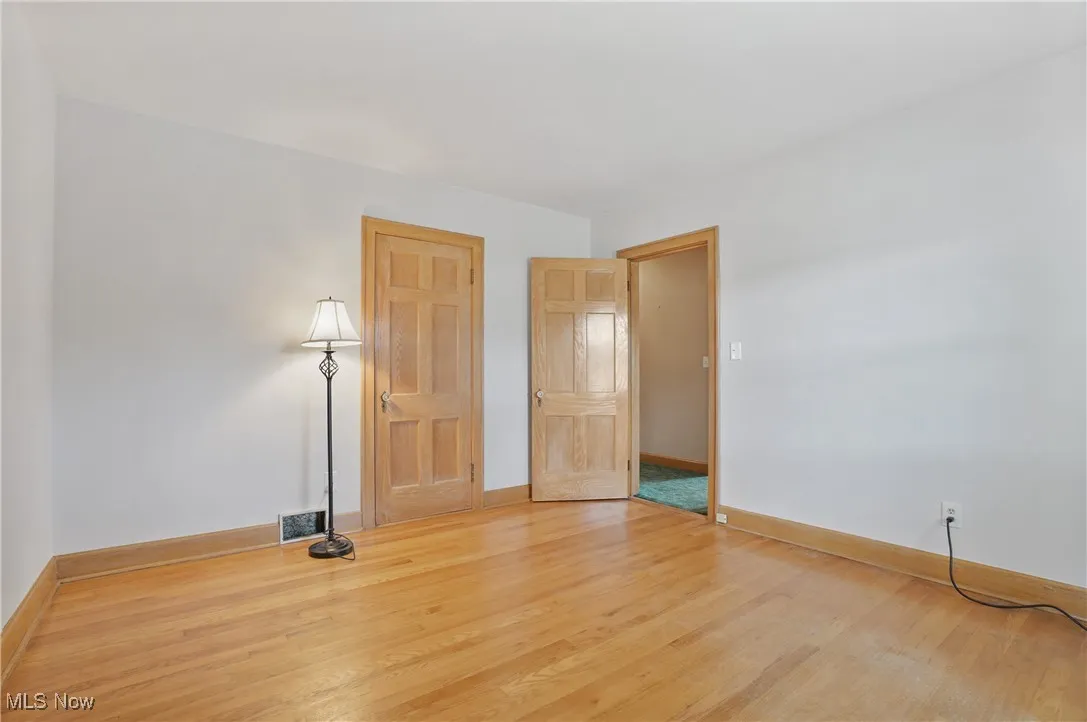 Empty room with wood finished floors and baseboards