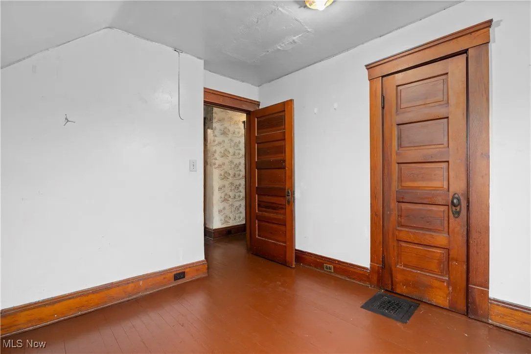 Empty room featuring wood finished floors and baseboards