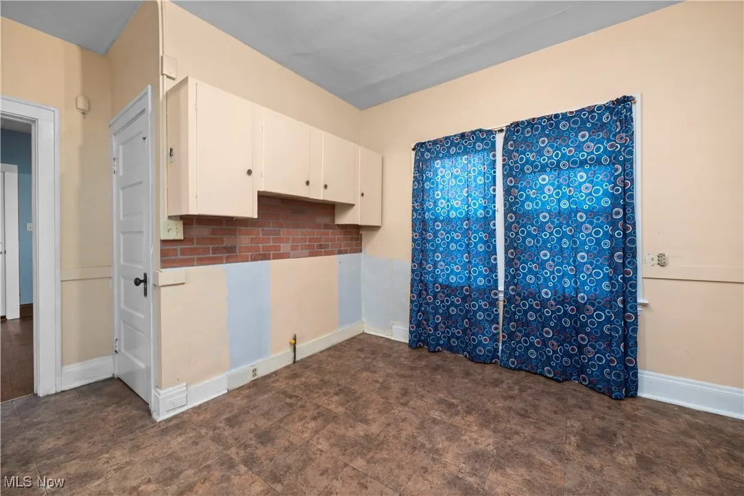 Kitchen featuring white cabinets and decorative backsplash