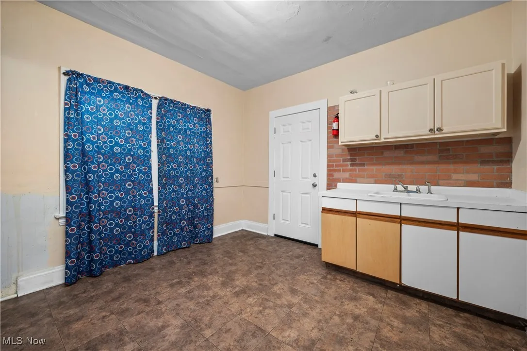 Kitchen with light countertops and white cabinets