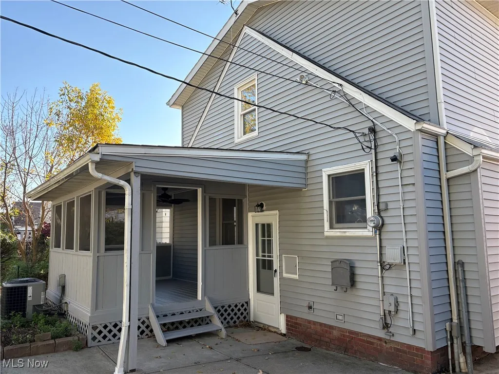 Rear view of house with a sunroom