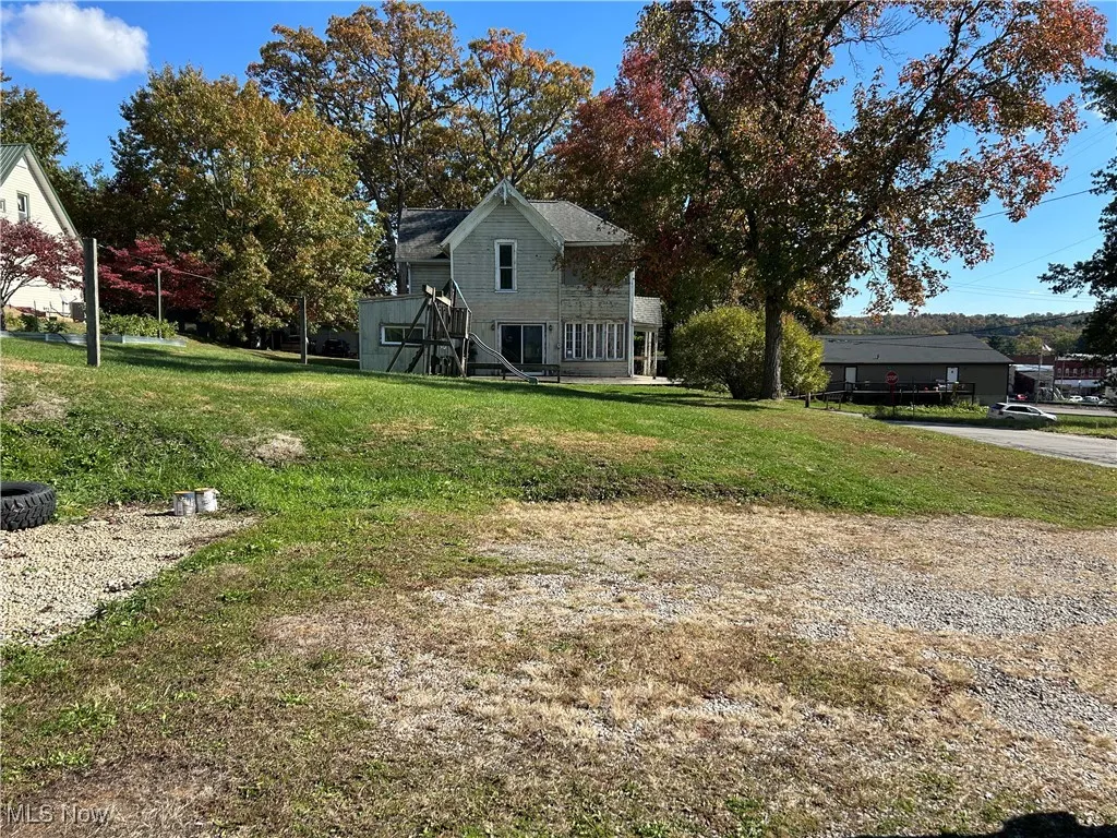 View of grassy yard with stairs