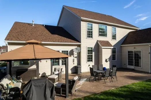 Rear view of property featuring a patio