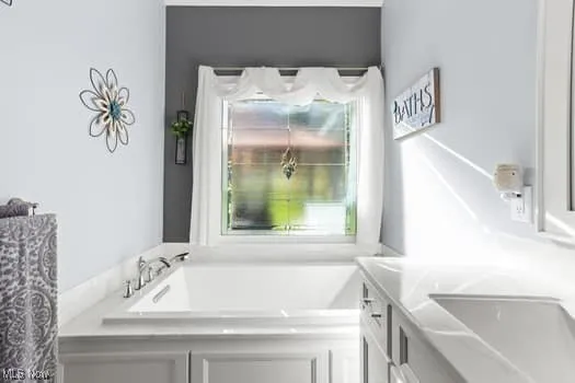 Bathroom featuring vanity and a garden tub