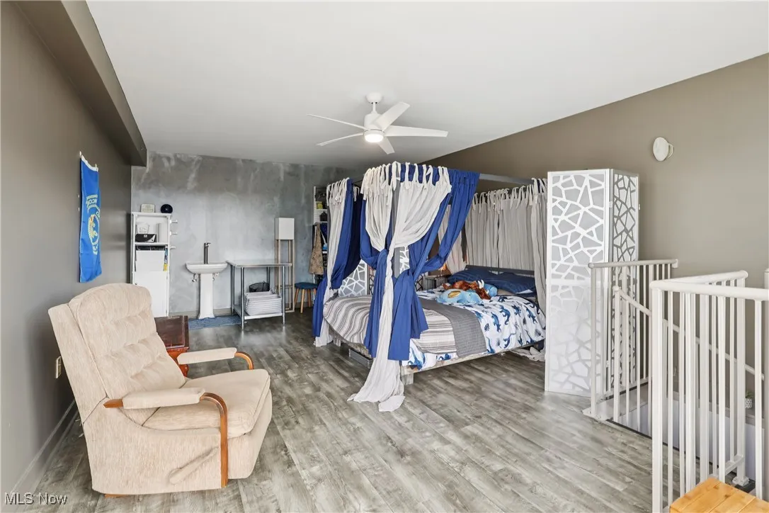 Bedroom featuring wood finished floors and a ceiling fan