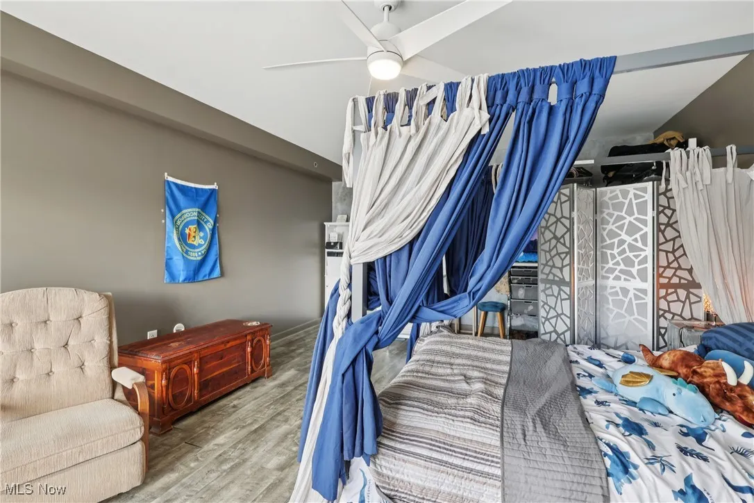 Bedroom with wood finished floors and a ceiling fan