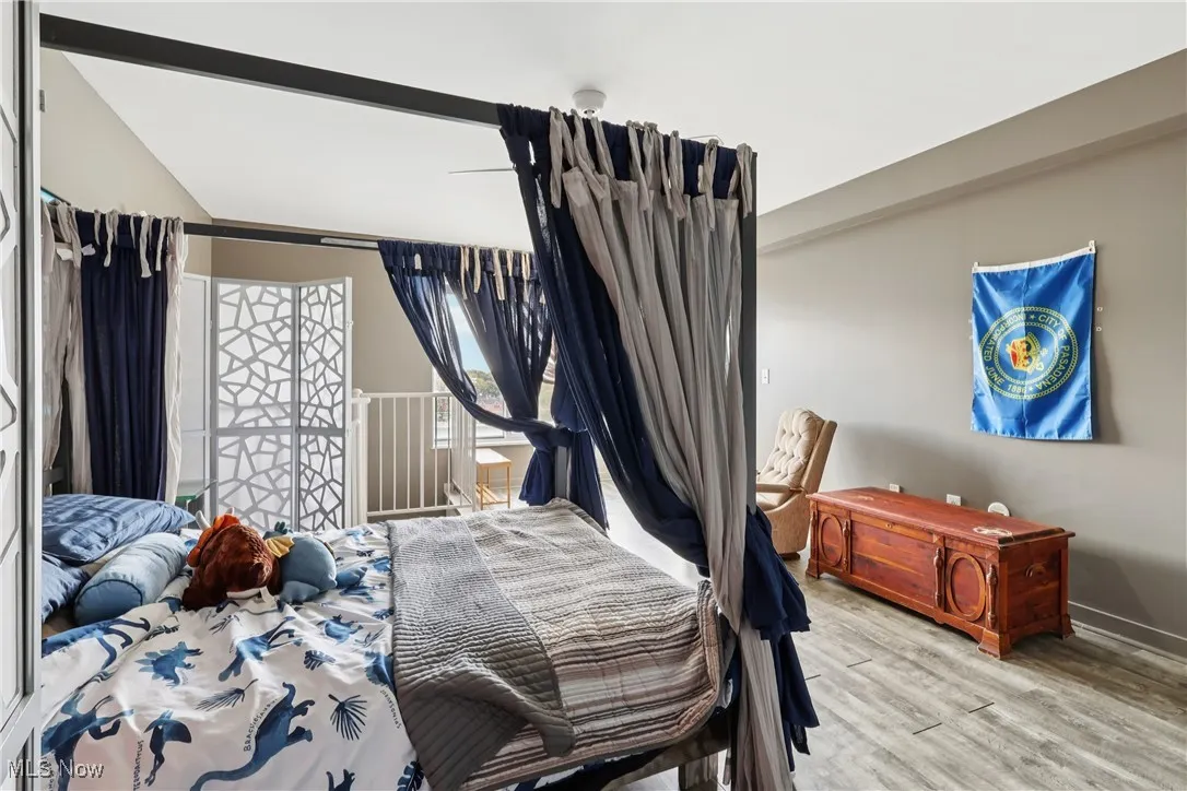 Bedroom featuring light wood-style flooring and baseboards