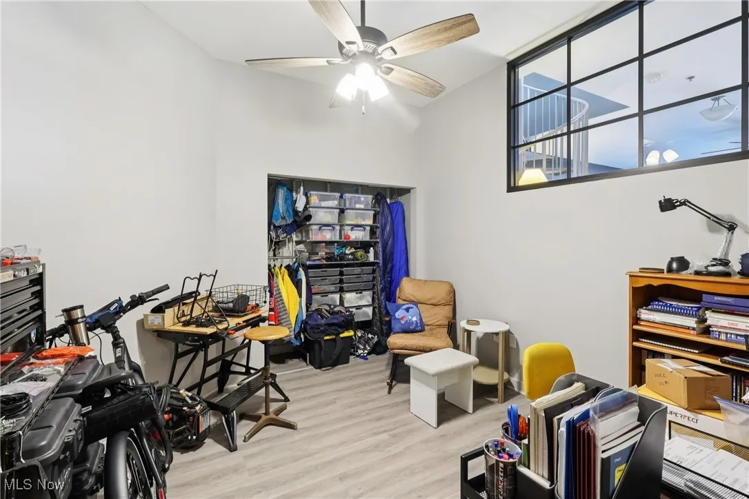 bedroom used as office with wood finished floors and a ceiling fan