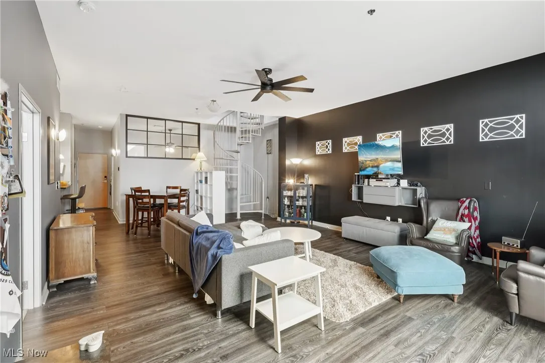 Living area featuring a ceiling fan and wood finished floors