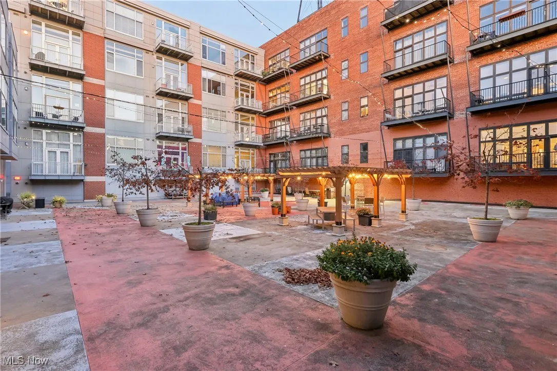 View of property's community featuring a workshop area and a pergola