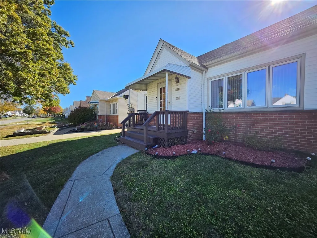 View of front of home with a front yard and brick siding