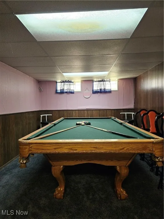 Recreation room featuring wood walls, billiards, a drop ceiling, and carpet floors