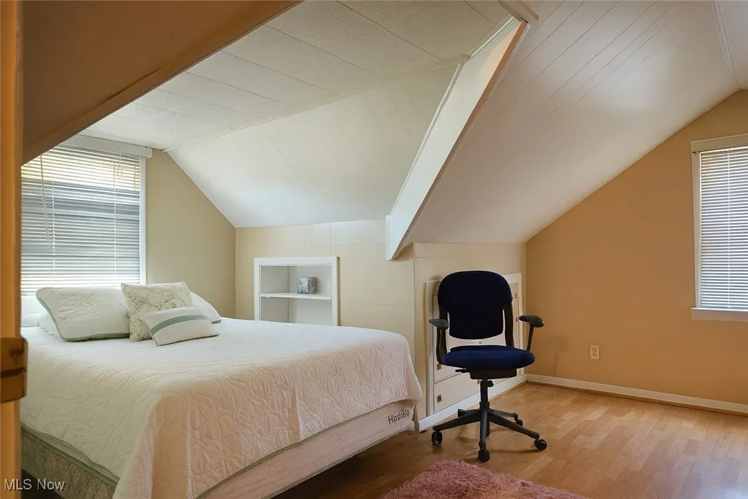 Bedroom featuring lofted ceiling and light wood finished floors