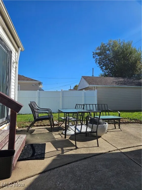Fenced backyard with a patio and outdoor dining area