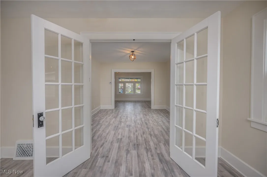 Corridor featuring baseboards and wood finished floors