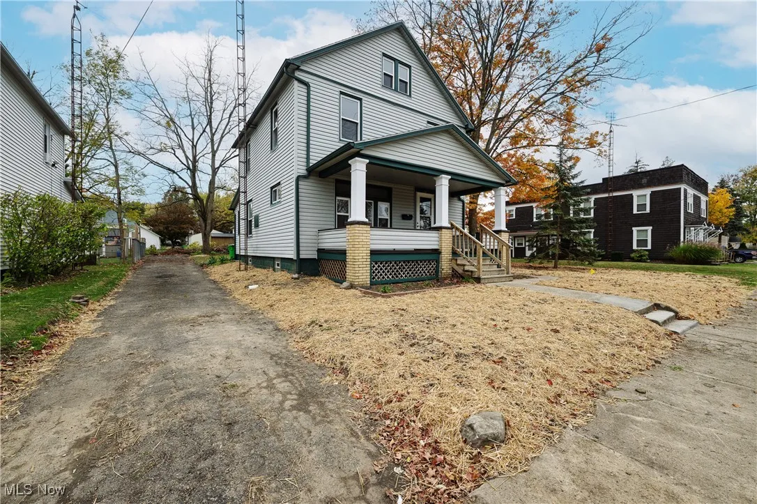 American foursquare style home with a porch and asphalt driveway