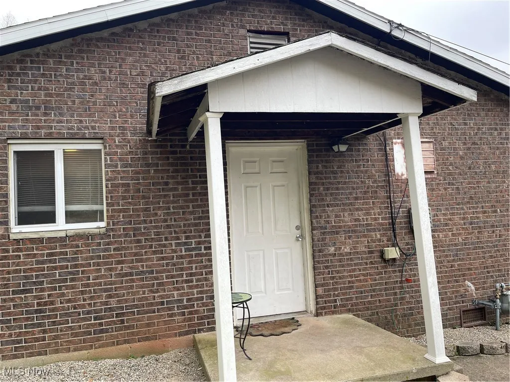 Side view of home with a small porch.