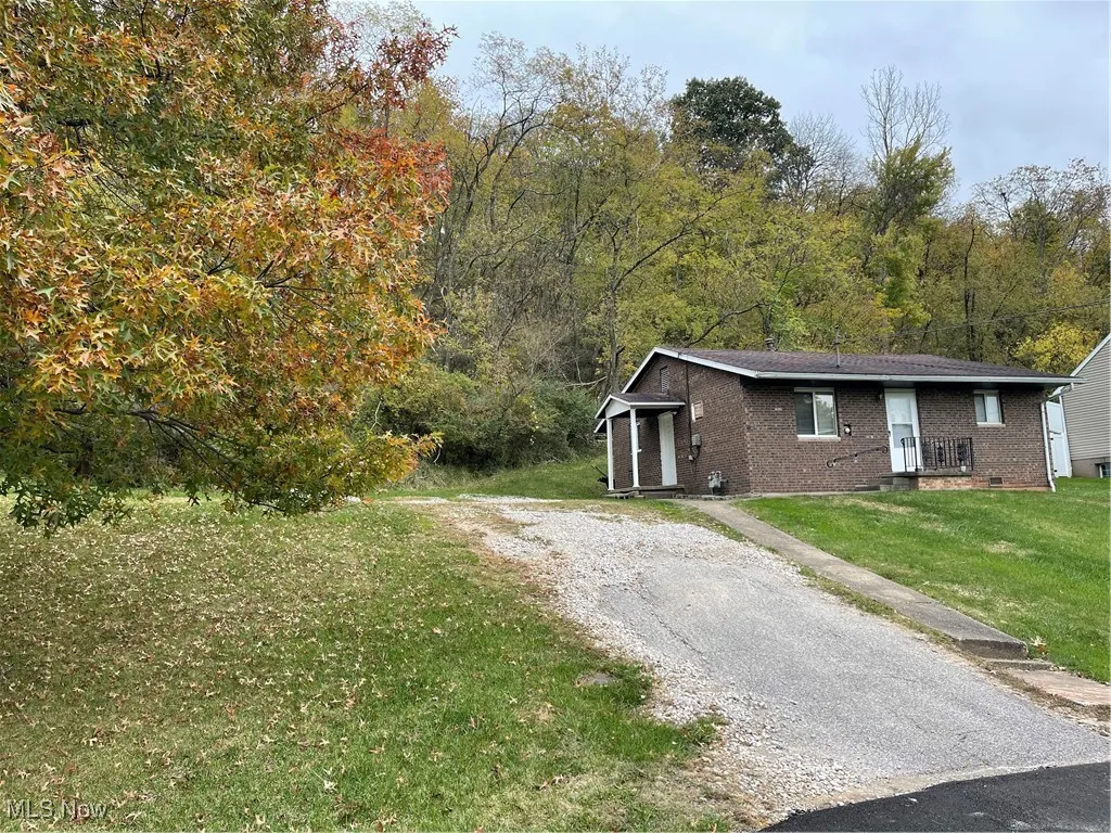View of front of home with front yard and driveway
