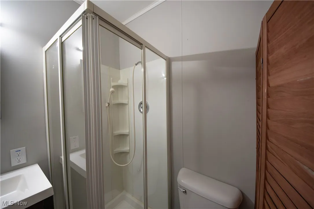 Full bathroom featuring vanity and a shower stall