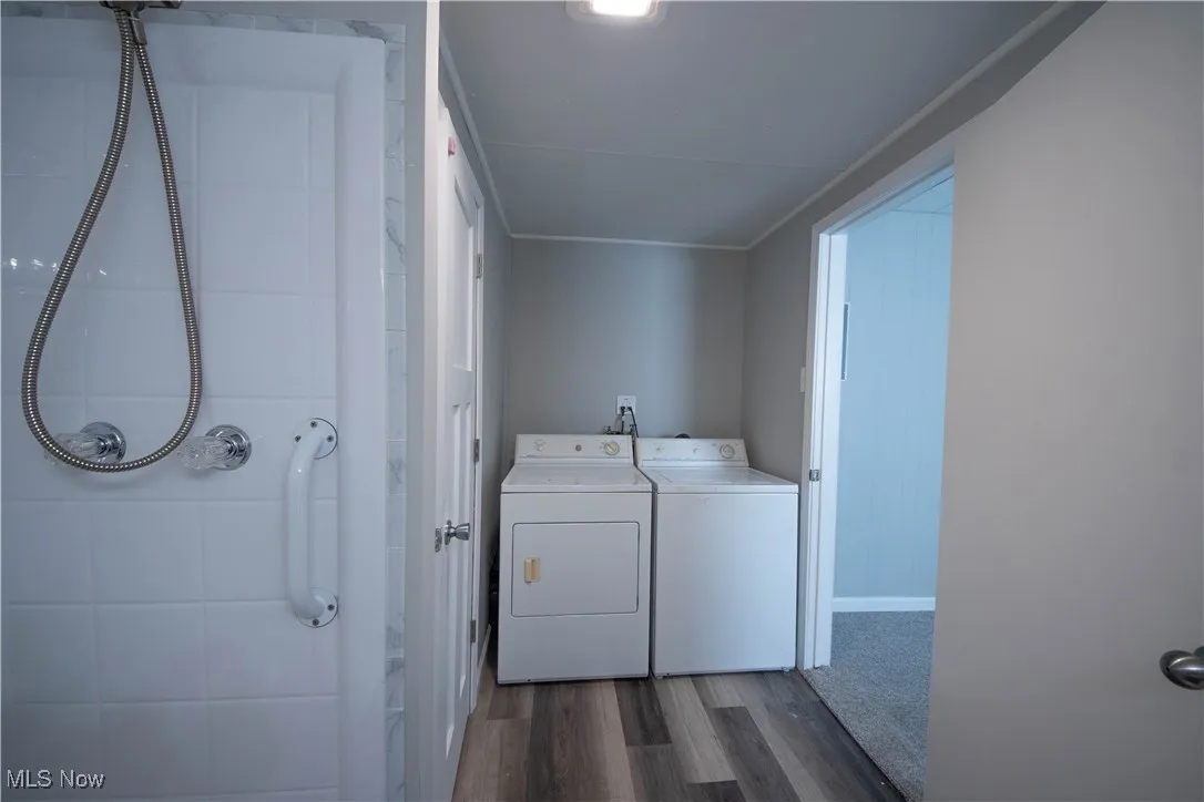 Laundry area featuring dark wood-type flooring and washer and dryer