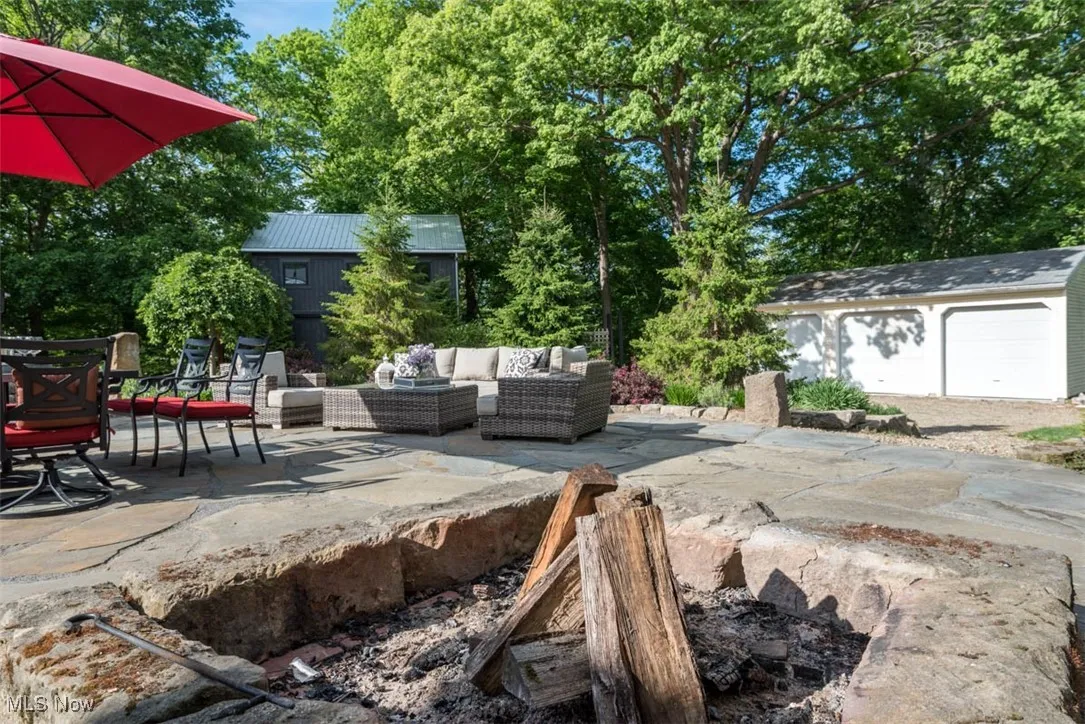 One-of-a-kind custom barnstone boulder fire pit.