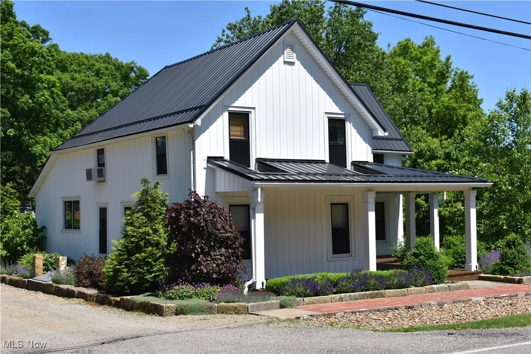 Barnstone boulders line the entrance, creating a striking framework that sets the tone for this distinctive property.