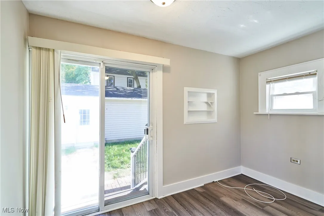 Dinette area featuring durable LVT (Luxury Vinyl Tile) flooring and a sliding glass door providing access to a conveniently fenced backyard.