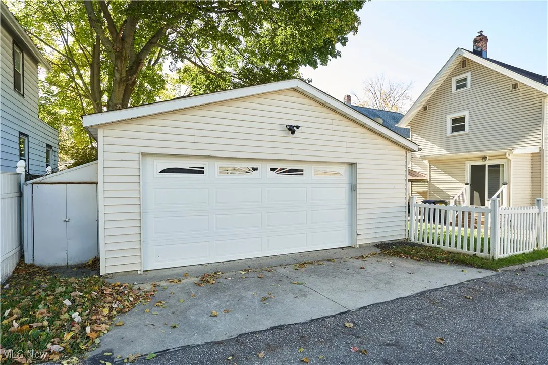 Newer 2 car garage with vinyl siding