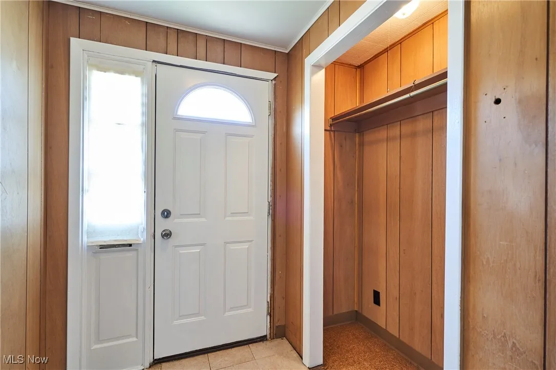 Foyer featuring wood paneled  walls