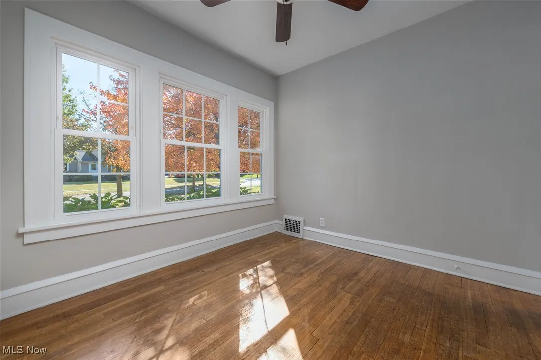 Spare room featuring wood-type flooring and ceiling fan