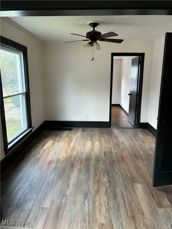 Spare room featuring wood finished floors and a ceiling fan