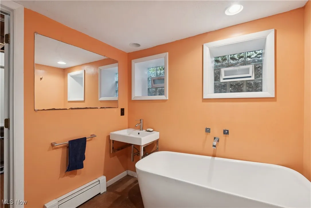 Updated bath with shower shared by the bedrooms and family room on the lower level.