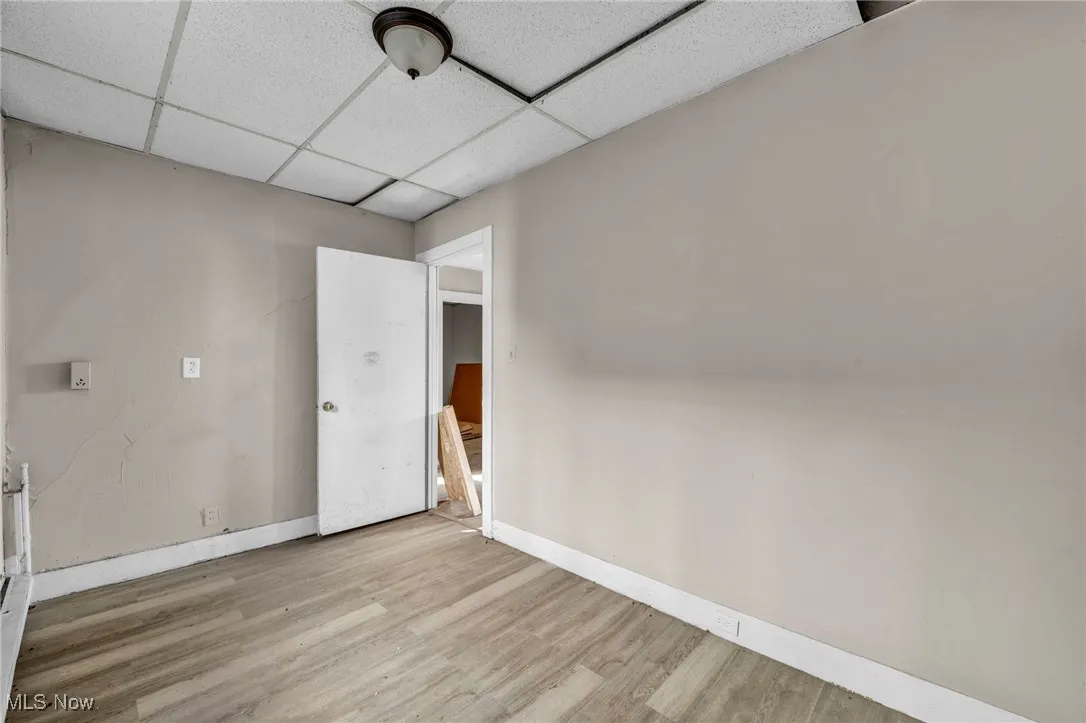 Additional living space featuring wood finished floors and baseboards