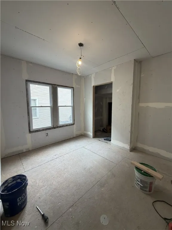 Unfurnished living room featuring baseboards