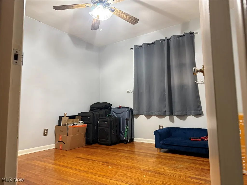 Unfurnished bedroom featuring wood finished floors and a ceiling fan