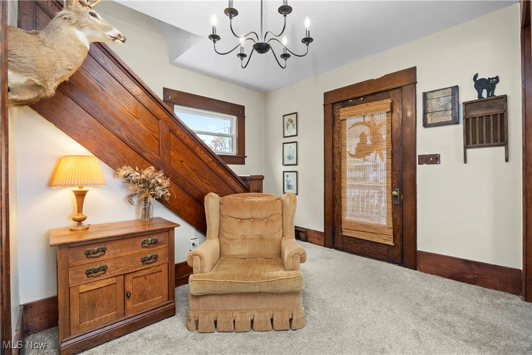Sitting room featuring carpet flooring and a chandelier