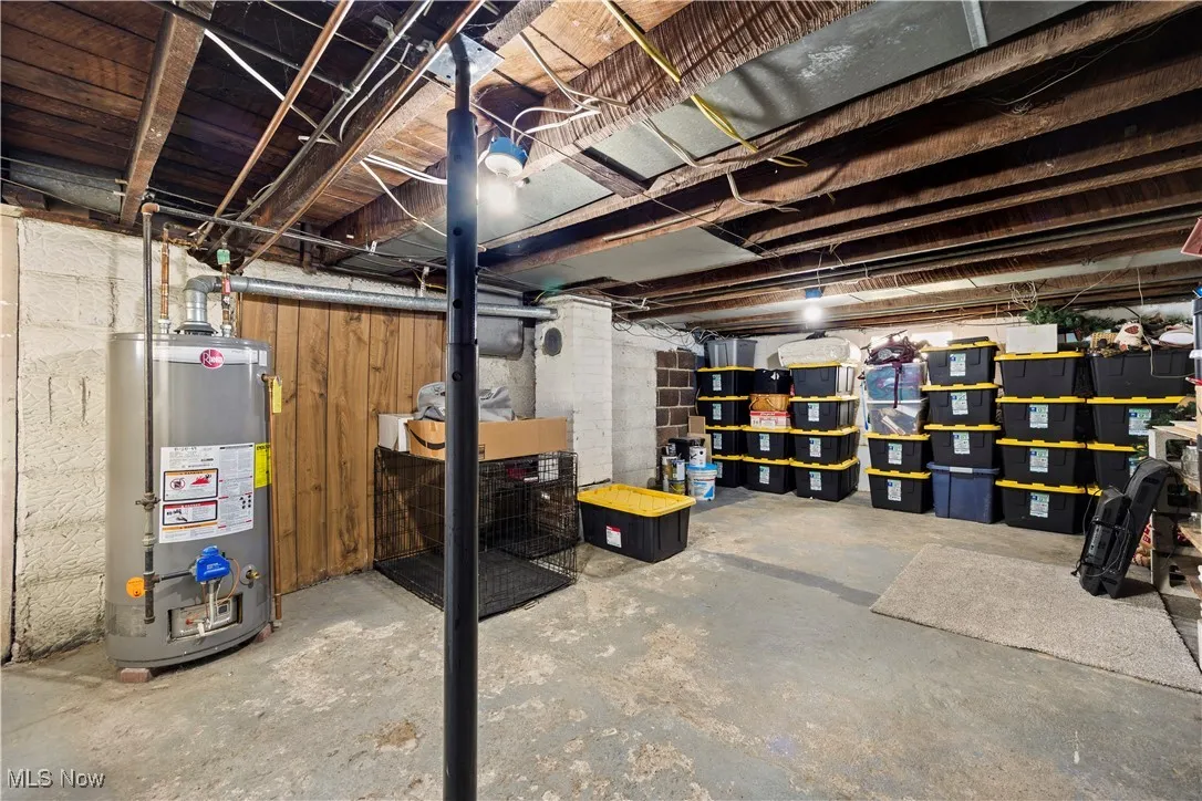 Unfinished basement featuring gas water heater