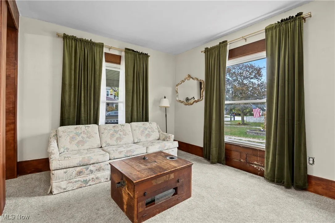 Living area with plenty of natural light and carpet