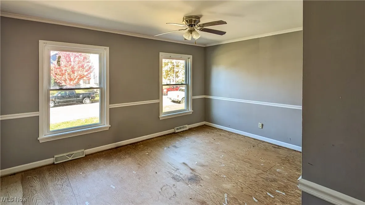 Unfurnished room with crown molding and ceiling fan
