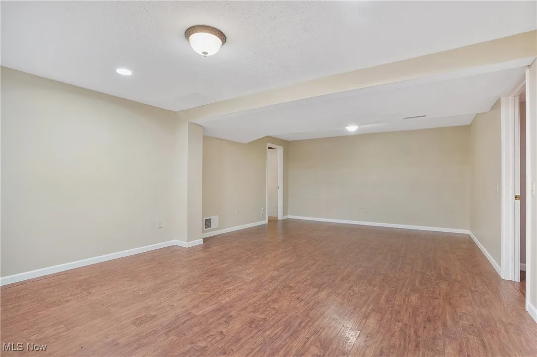 Empty room featuring light wood-style floors and recessed lighting