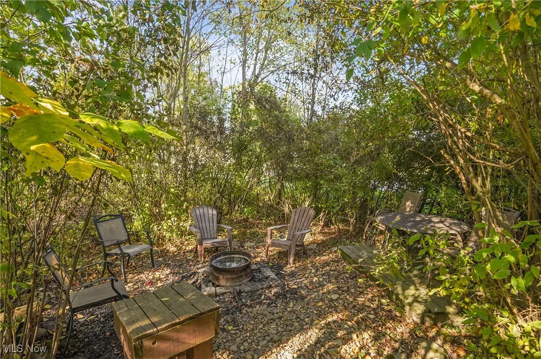 View of patio with an outdoor fire pit