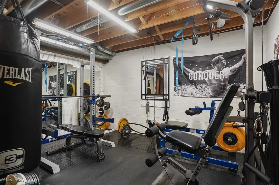 Exercise area featuring rubber floors and concrete block wall